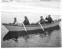 Image of Three White men, 1 Inuit in dory